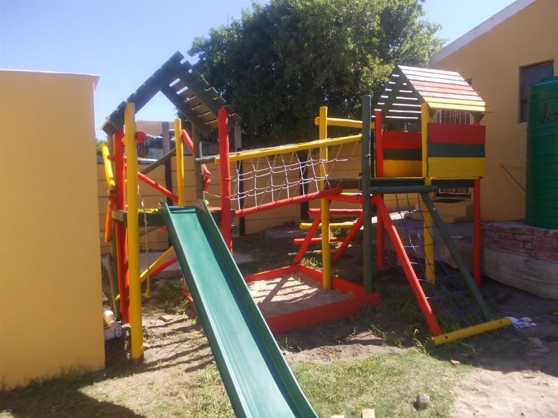 Colourful painted play structure with climbing net